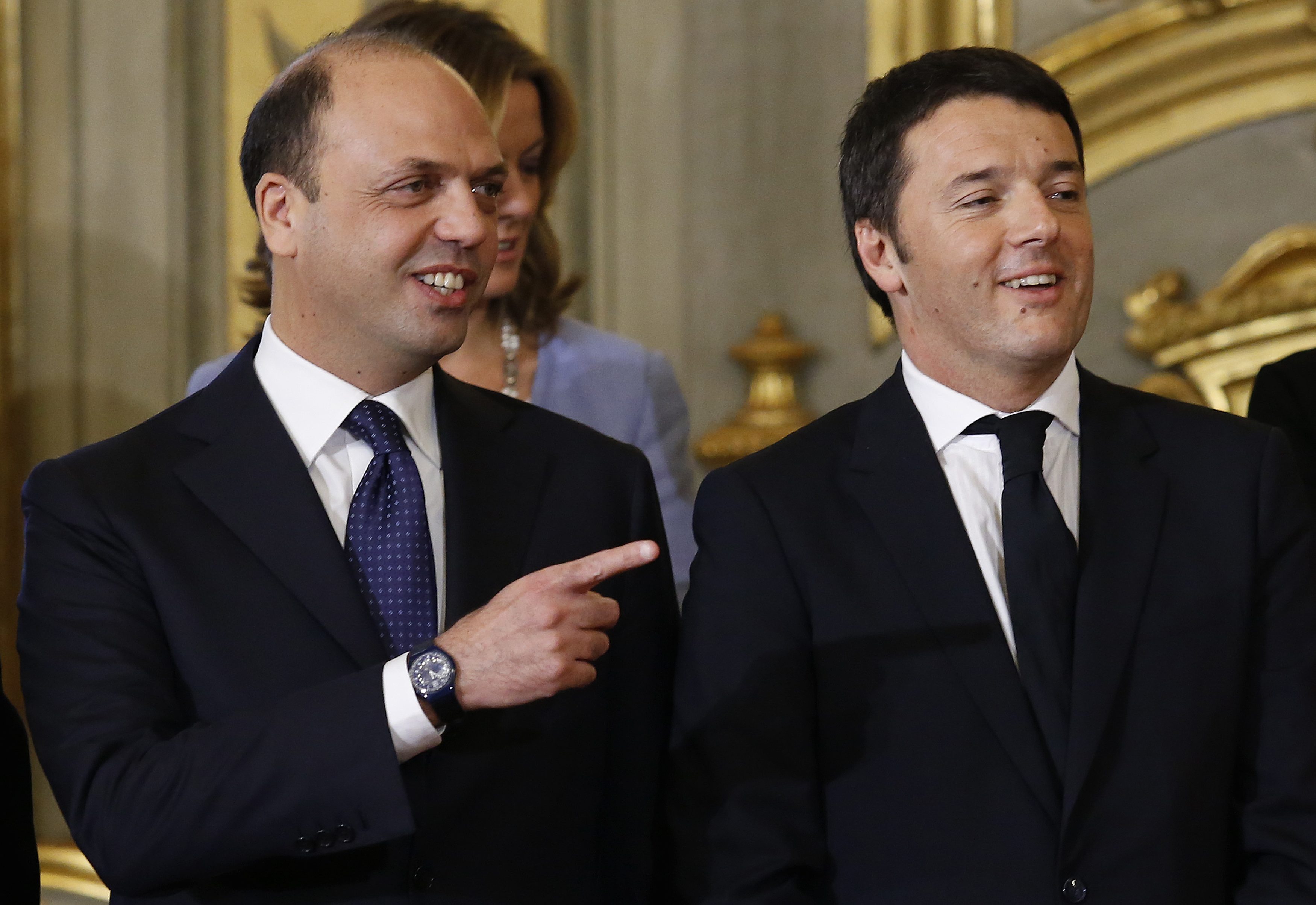 Newly appointed Italian Prime Minister Matteo Renzi (R) and Interior Minister Angelino Alfano talk during a swearing-in ceremony at Quirinale Palace in Rome February 22, 2014. Italian center-left leader Renzi promised on Friday to start work on reforms immediately, after he named a new cabinet and formally accepted the mandate to form an administration he said would stay in place until 2018. REUTERS/Remo Casilli  (ITALY - Tags: POLITICS)